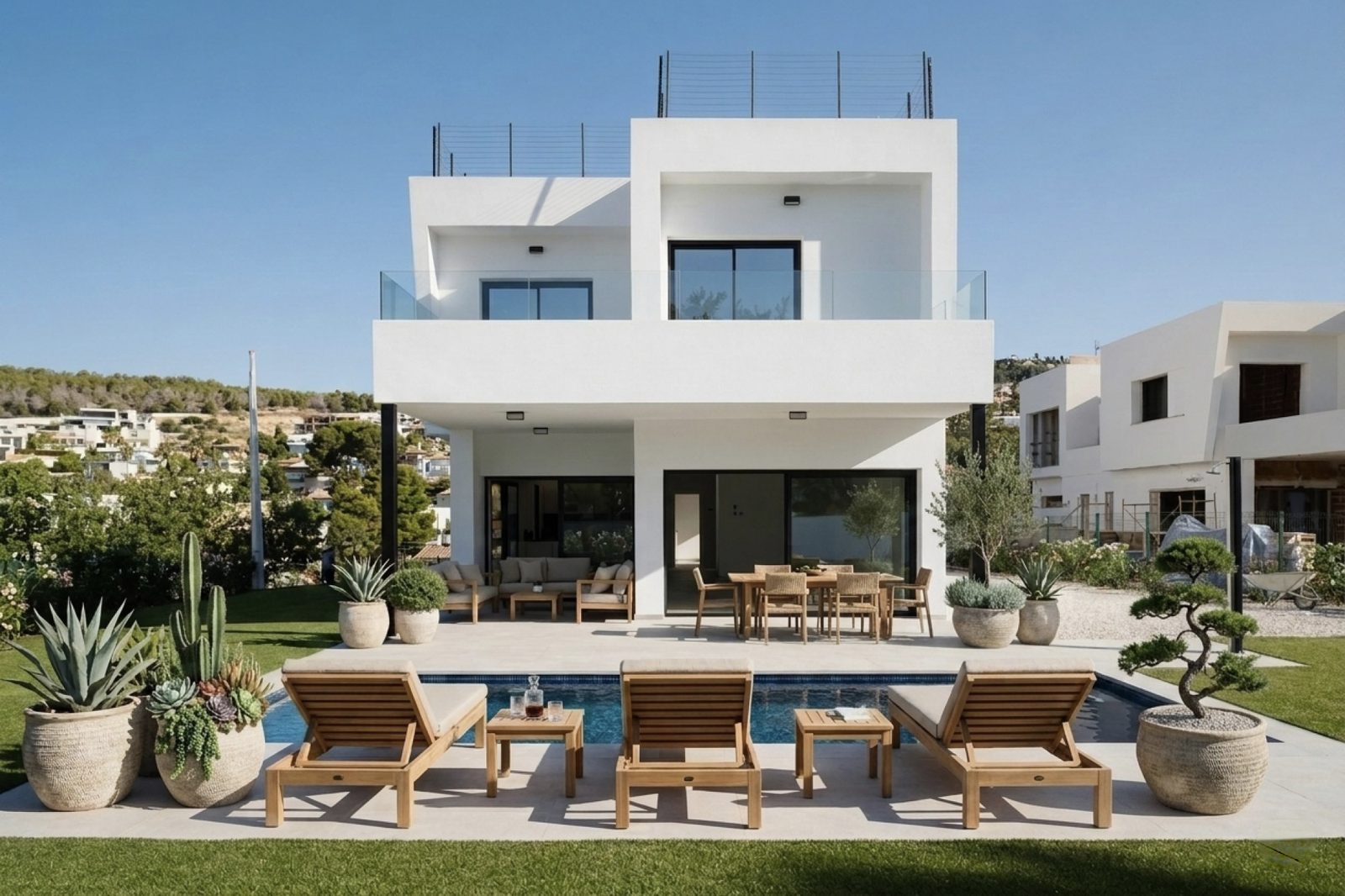 A modern villa with a pool and outdoor dining area in Calpe - The Estates