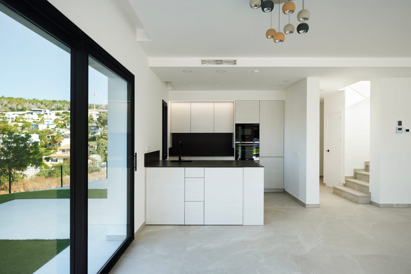 Modern kitchen with city and mountain views inside a 3-bedroom villa in Calpe - The Estates