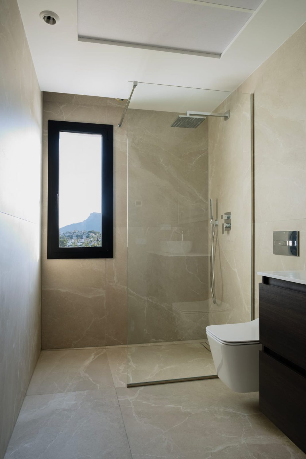 A modern bathroom with a walk-in shower and mountain view in a 3-bedroom villa in Calpe - The Estates