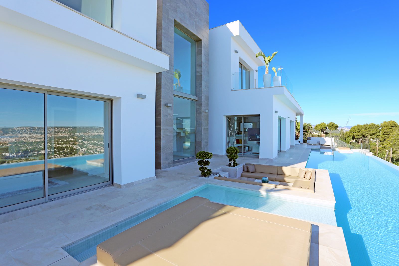 Modern exterior of a 4-bedroom villa in Javea with a pool and stunning sea views - The Estates