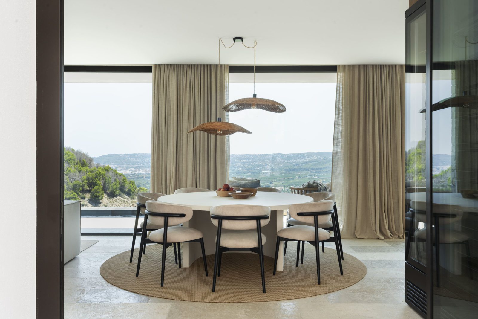 Elegant dining area with stunning sea and mountain views inside a 5-bedroom villa in Javea - The Estates