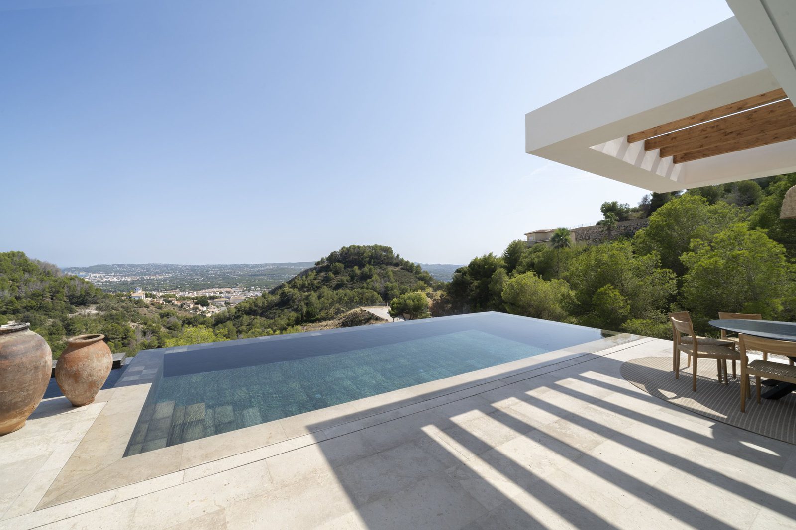 A stunning pool and terrace with mountain and sea views of a 5-bedroom villa in Javea - The Estates