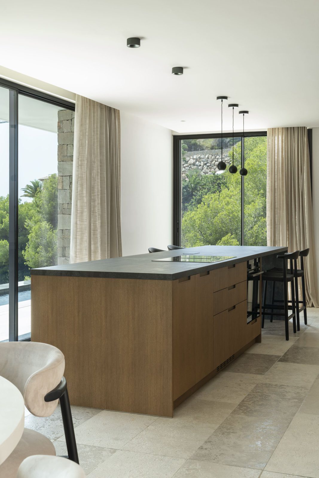 Modern kitchen island with stunning sea, mountain, and countryside views of a 5-bedroom villa in Javea - The Estates