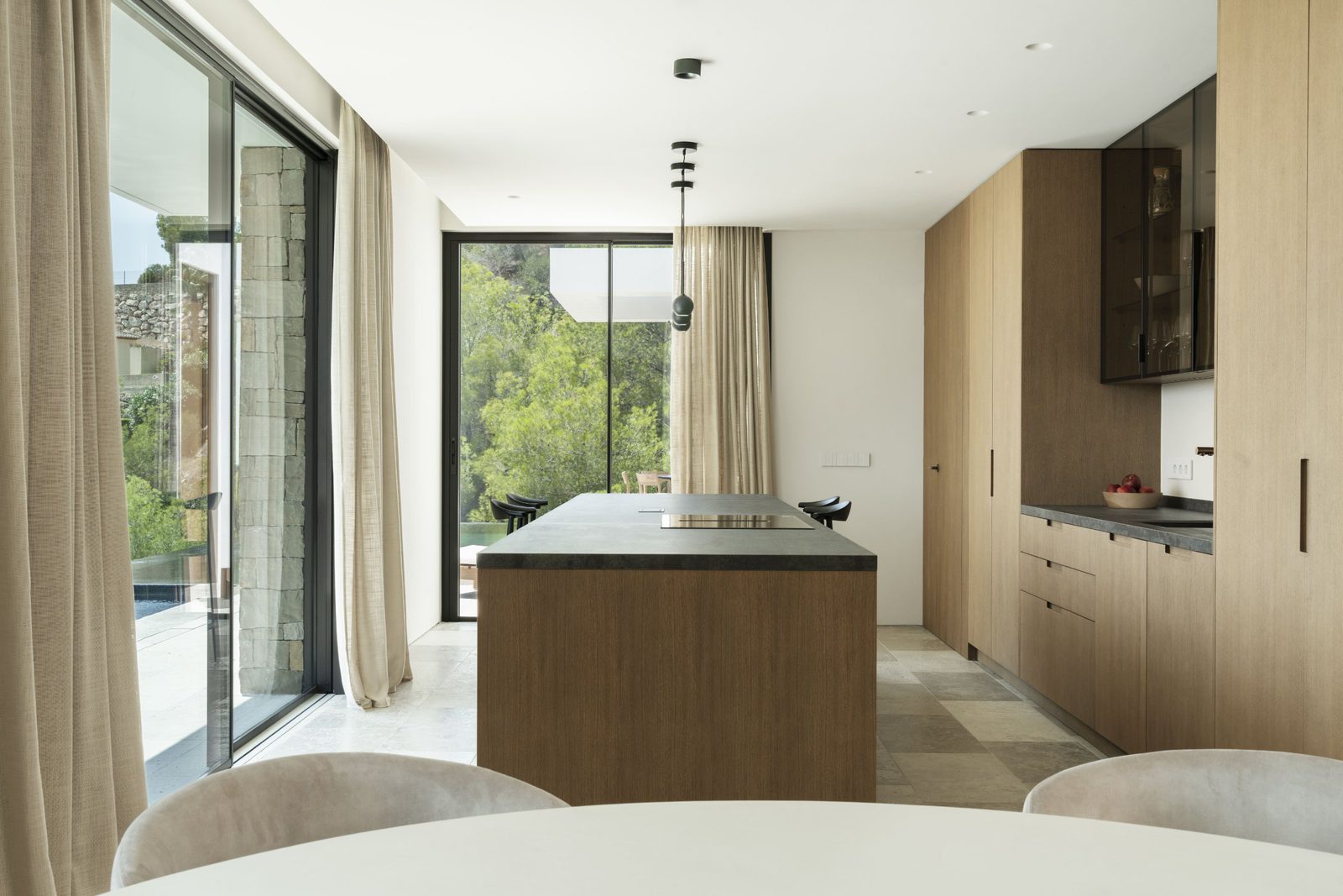 Modern kitchen with island and stunning sea, mountain, and countryside views of a 5-bedroom villa in Javea - The Estates