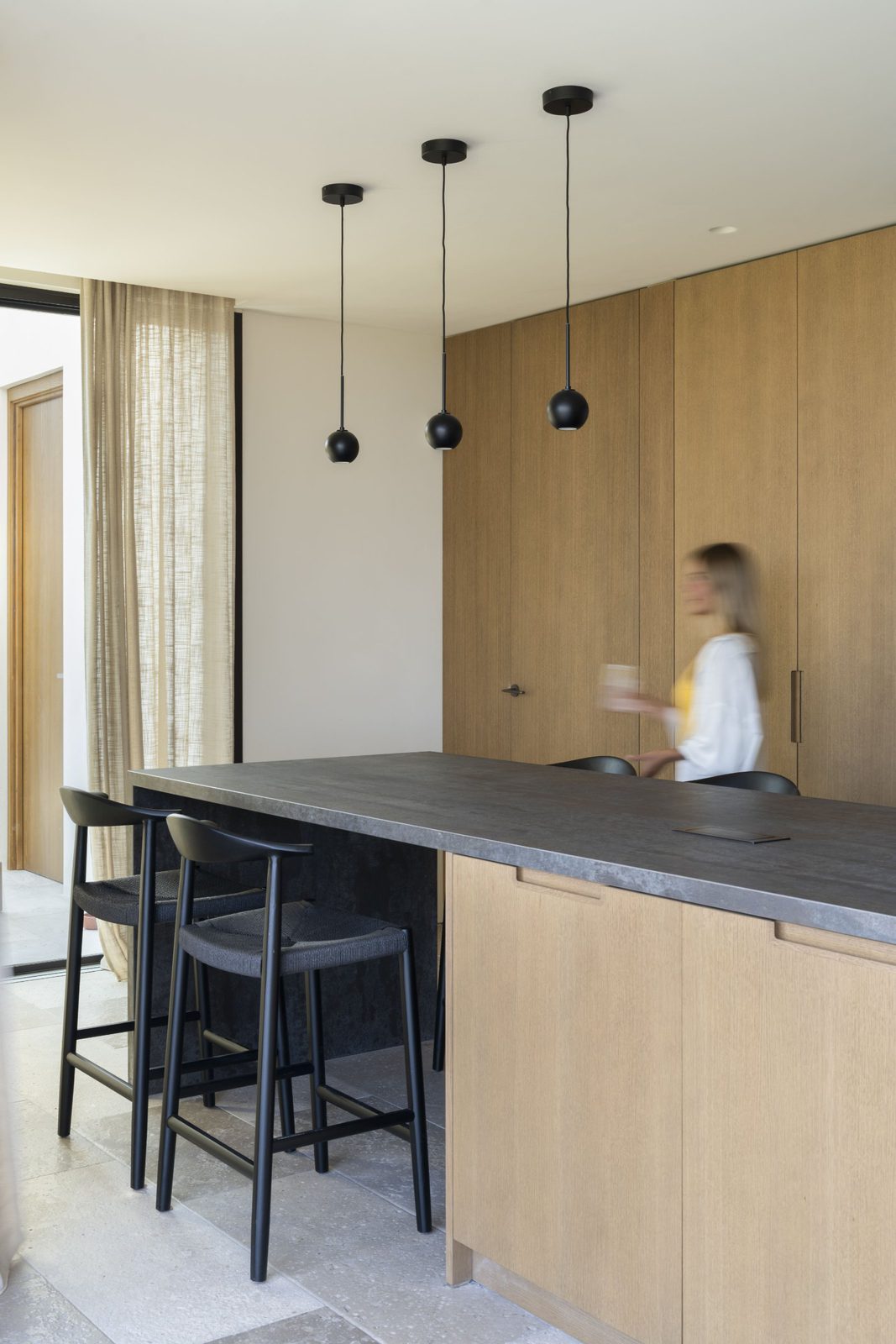 Modern kitchen island and seating area of a 5-bedroom villa in Javea - The Estates
