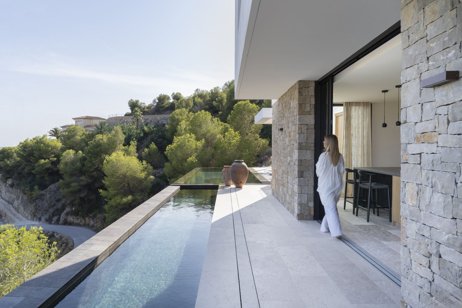 Modern exterior with infinity pool and lush greenery of a 5-bedroom villa in Javea - The Estates