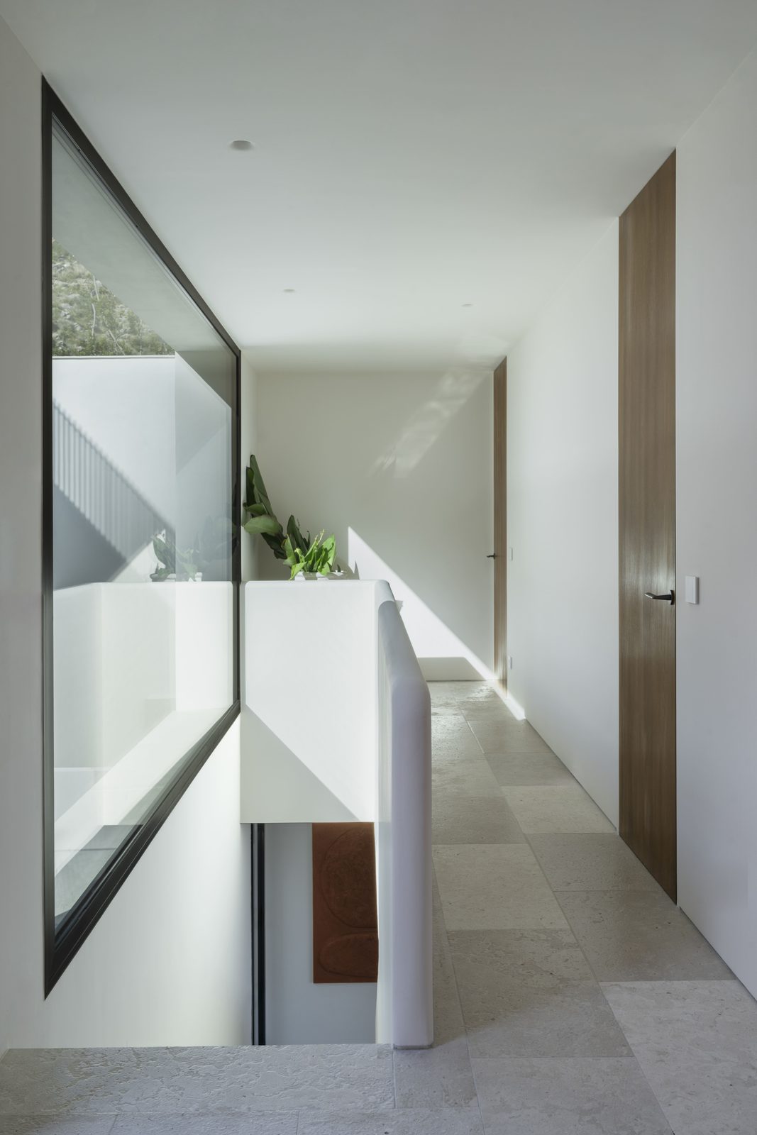 Modern interior hallway with large window and greenery view of a 5-bedroom villa in Javea - The Estates
