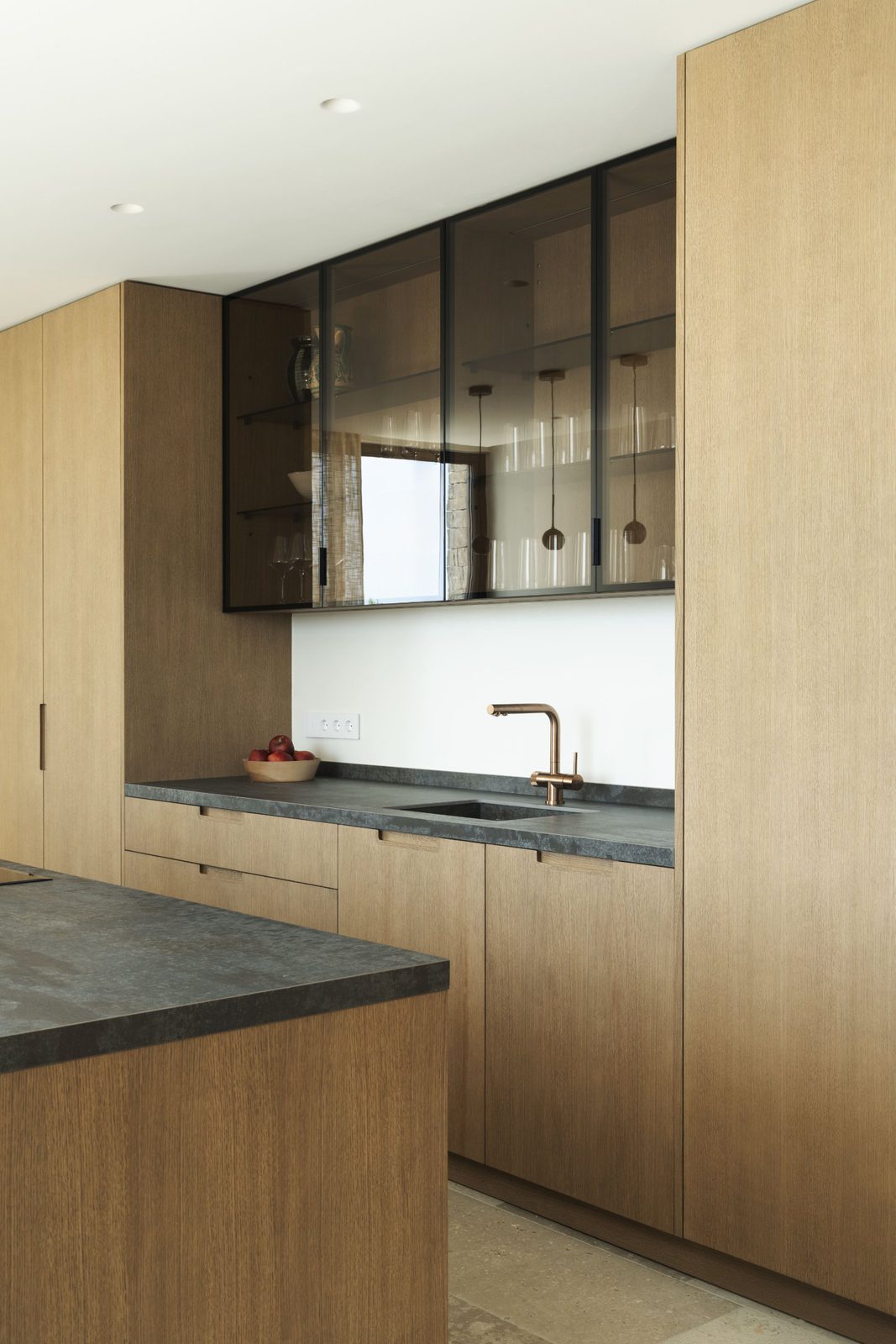 Stylish kitchen with wooden cabinetry and a sleek sink in a 5-bedroom villa in Javea - The Estates