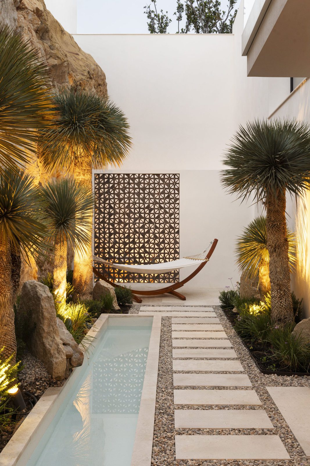 A tranquil garden area with a hammock and water feature at a 5-bedroom villa in Javea - The Estates
