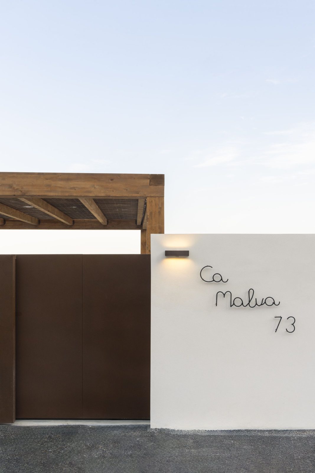 Stylish entrance to a 5-bedroom villa in Javea with a modern gate and signage - The Estates