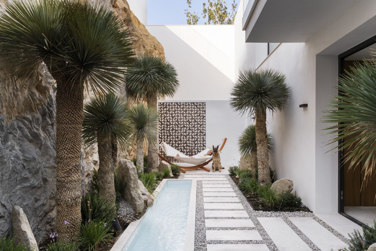 A tranquil garden path and seating area within a 5-bedroom villa in Javea - The Estates