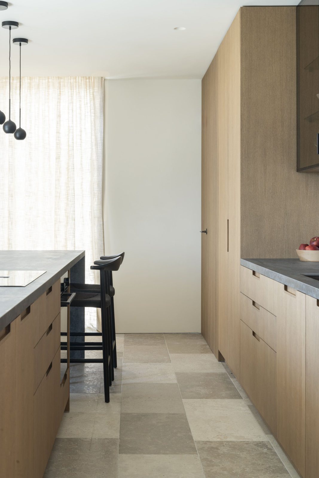 Modern kitchen with island and wood cabinetry in a 5-bedroom villa in Javea - The Estates
