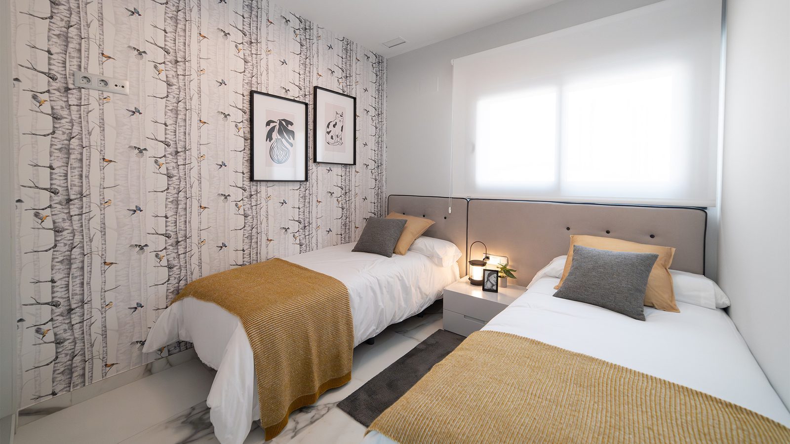 Twin bedroom with birch forest wallpaper, two beds and bedside table in a 3-bedroom apartment in Benidorm - The Estates