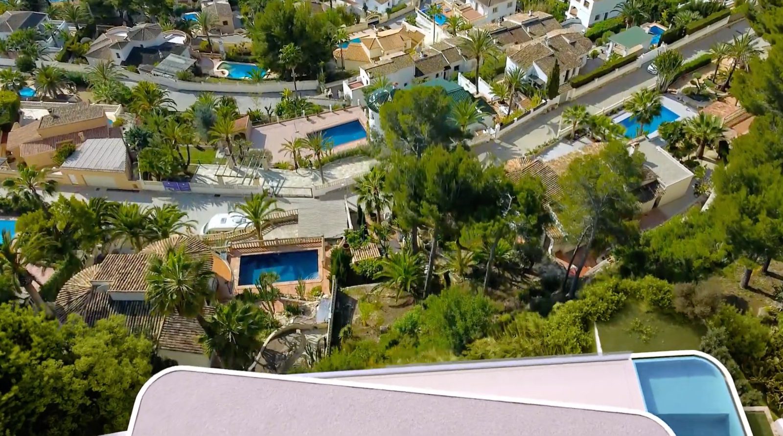 Aerial view of a beautiful villa and surrounding town in Moraira - The Estates