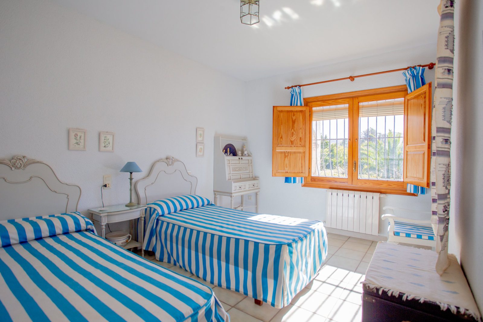 Bright bedroom with twin beds and a view of the countryside in a 4-bedroom villa in Javea - The Estates
