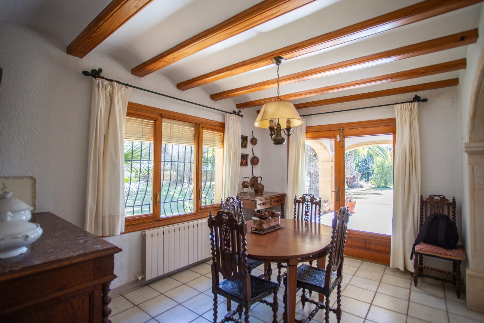 A charming dining area with exposed beams in a 4-bedroom villa in Javea - The Estates