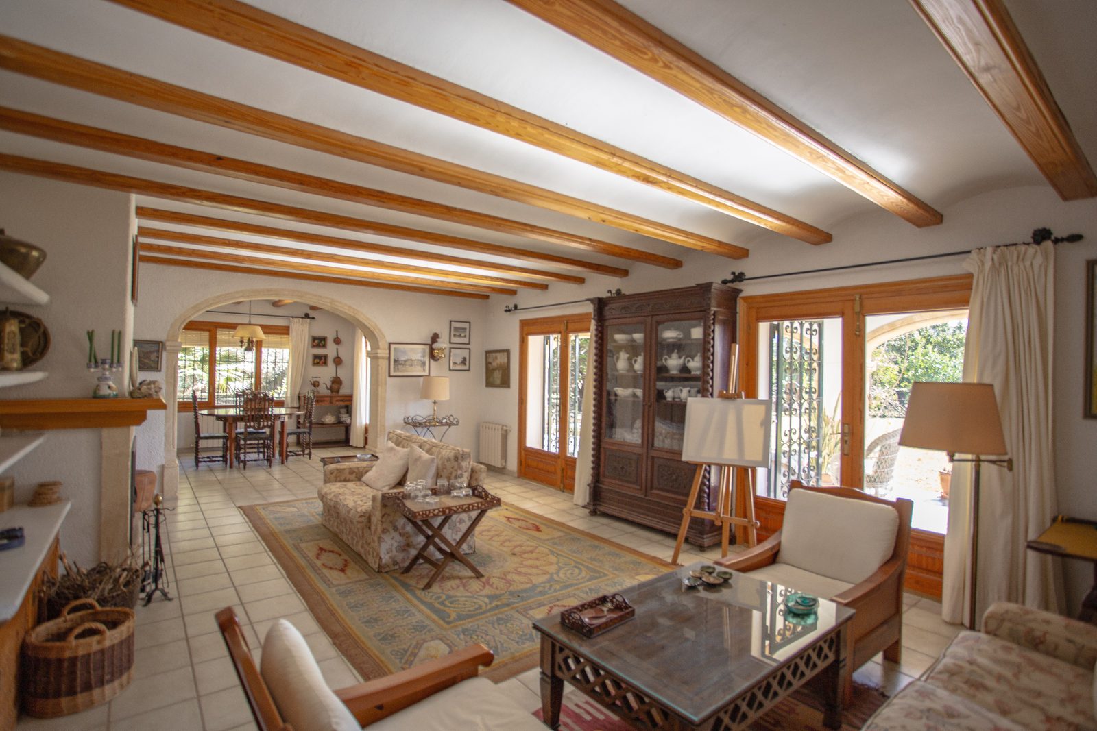 Interior view of a living room with wooden beams and views of the countryside in a 4-bedroom villa in Javea - The Estates
