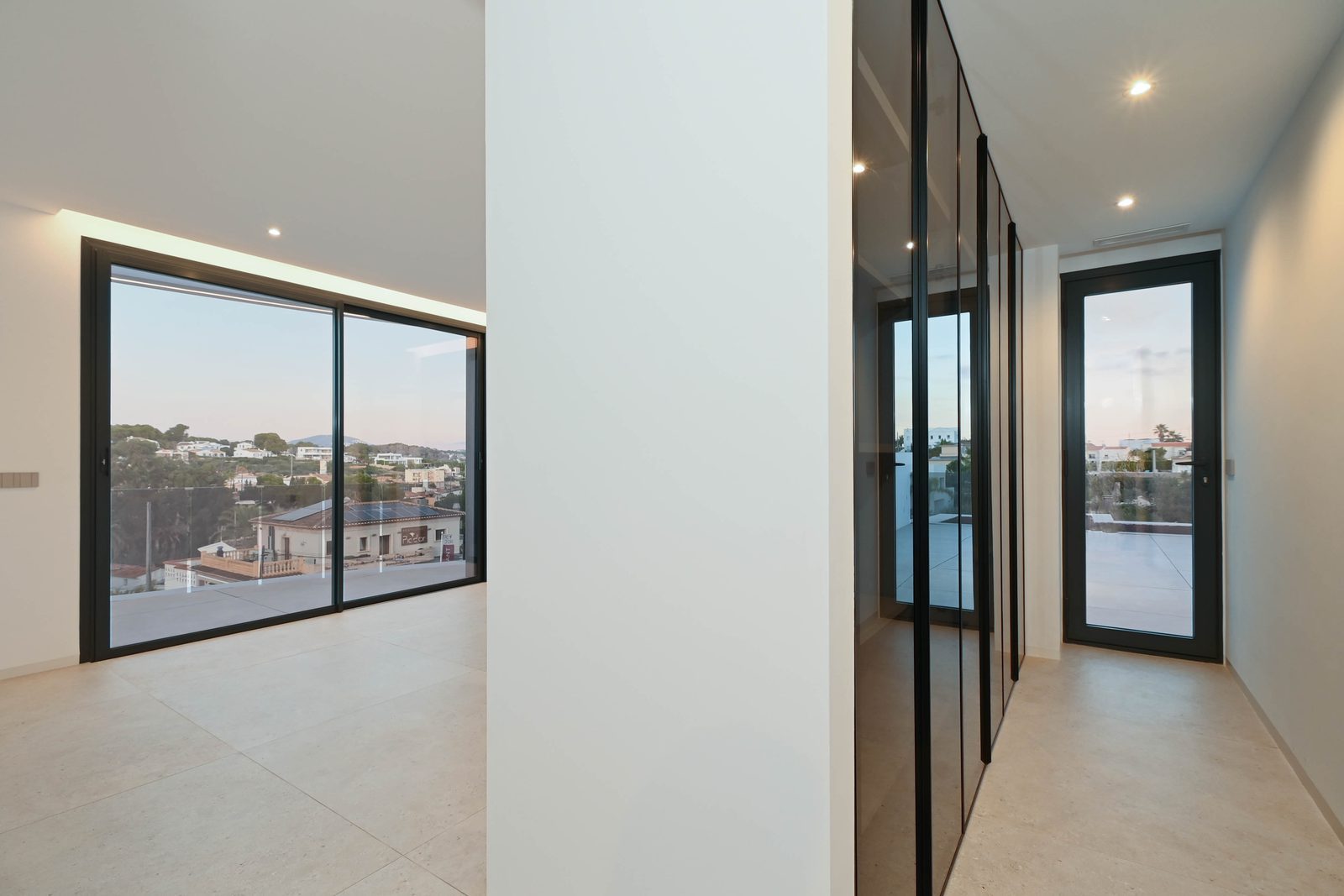 Bright modern hallway and open-plan room with sea views of a