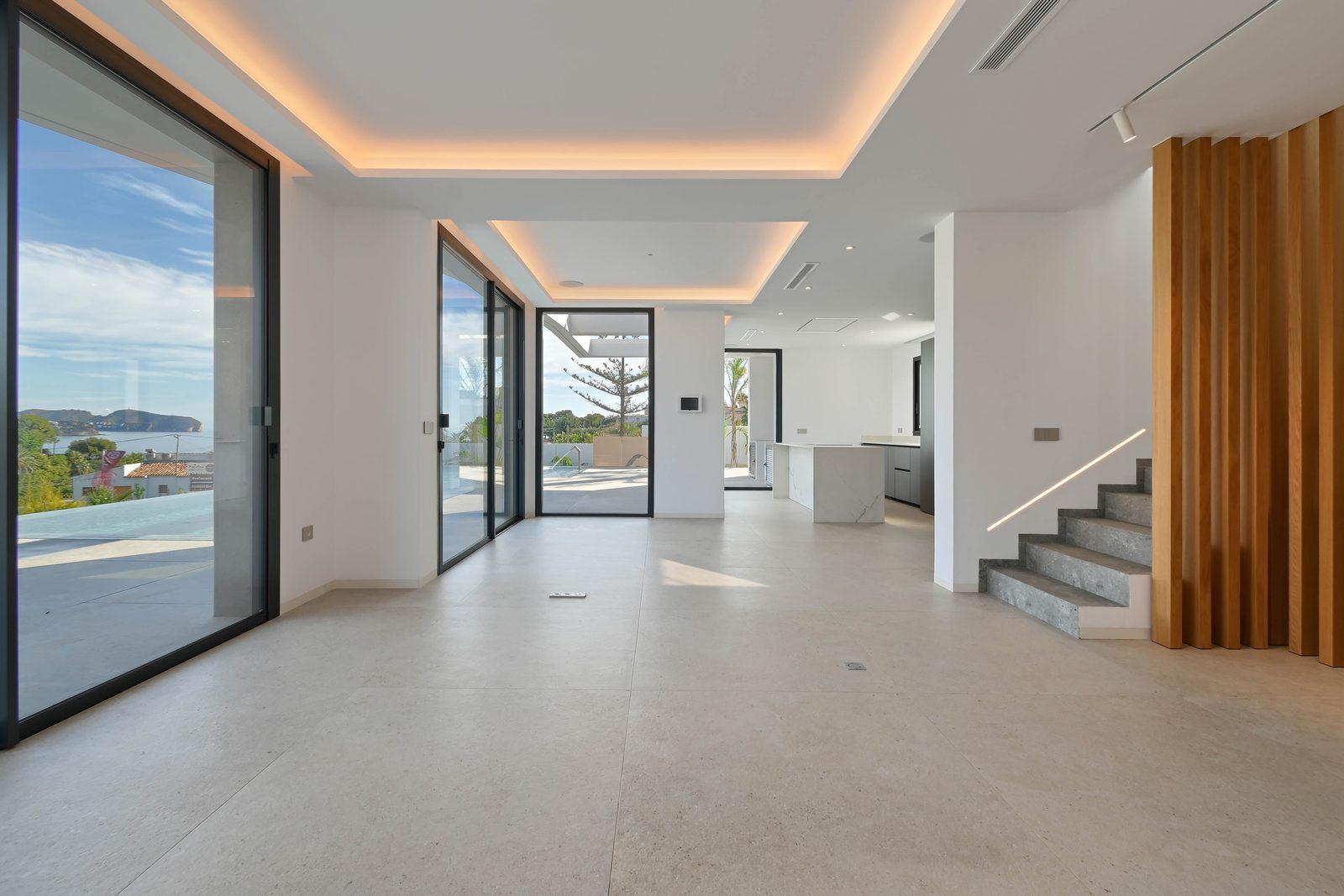 Open-plan living area with kitchen, sea views and contemporary staircase in a 4-bedroom villa in Benissa - The Estates