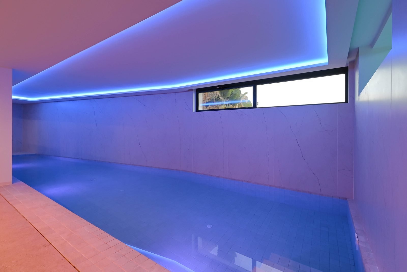 Indoor swimming pool with blue lighting in a 4-bedroom villa in Benissa - The Estates