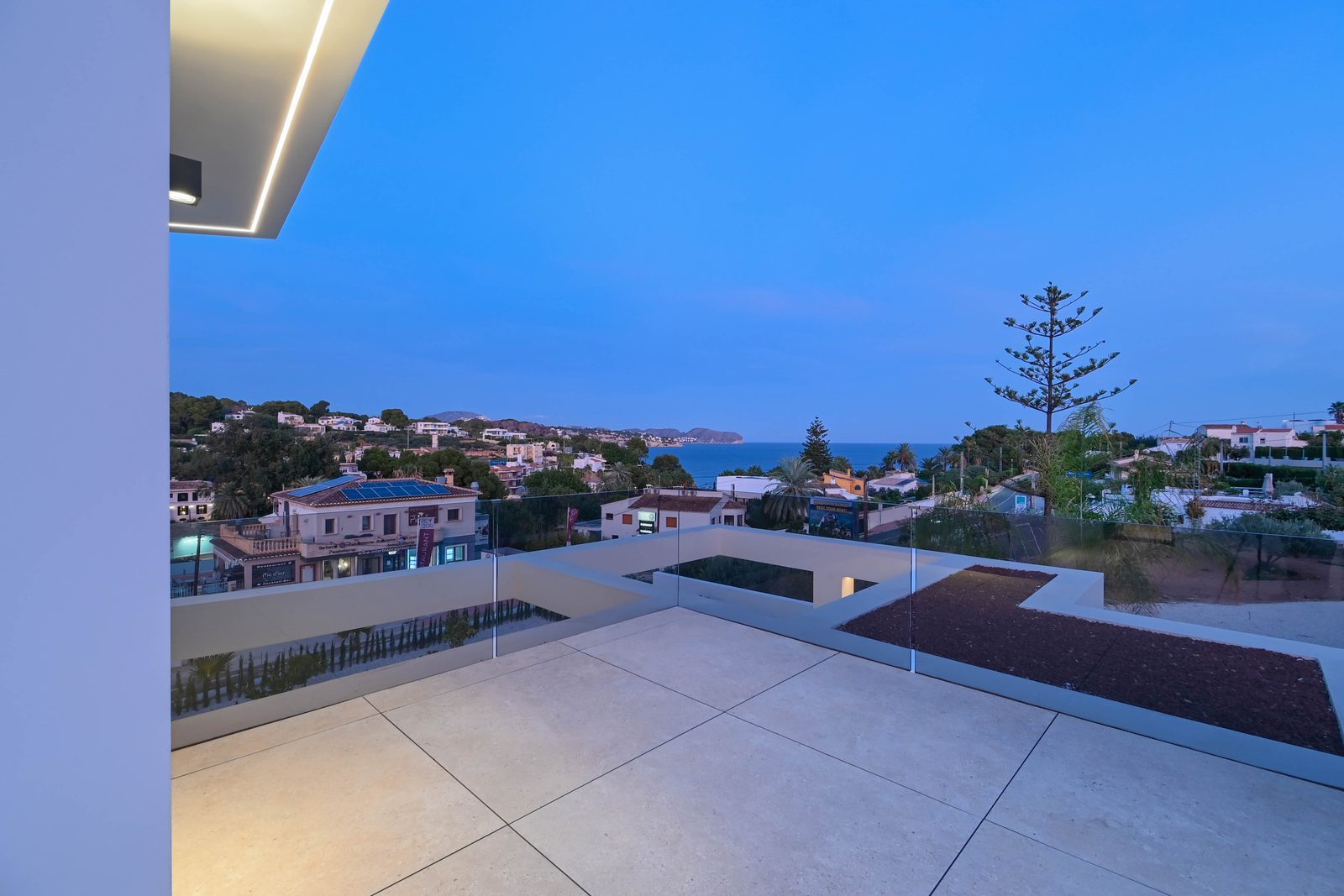 Rooftop terrace with glass balustrade and sea views of a 4-bedroom villa in