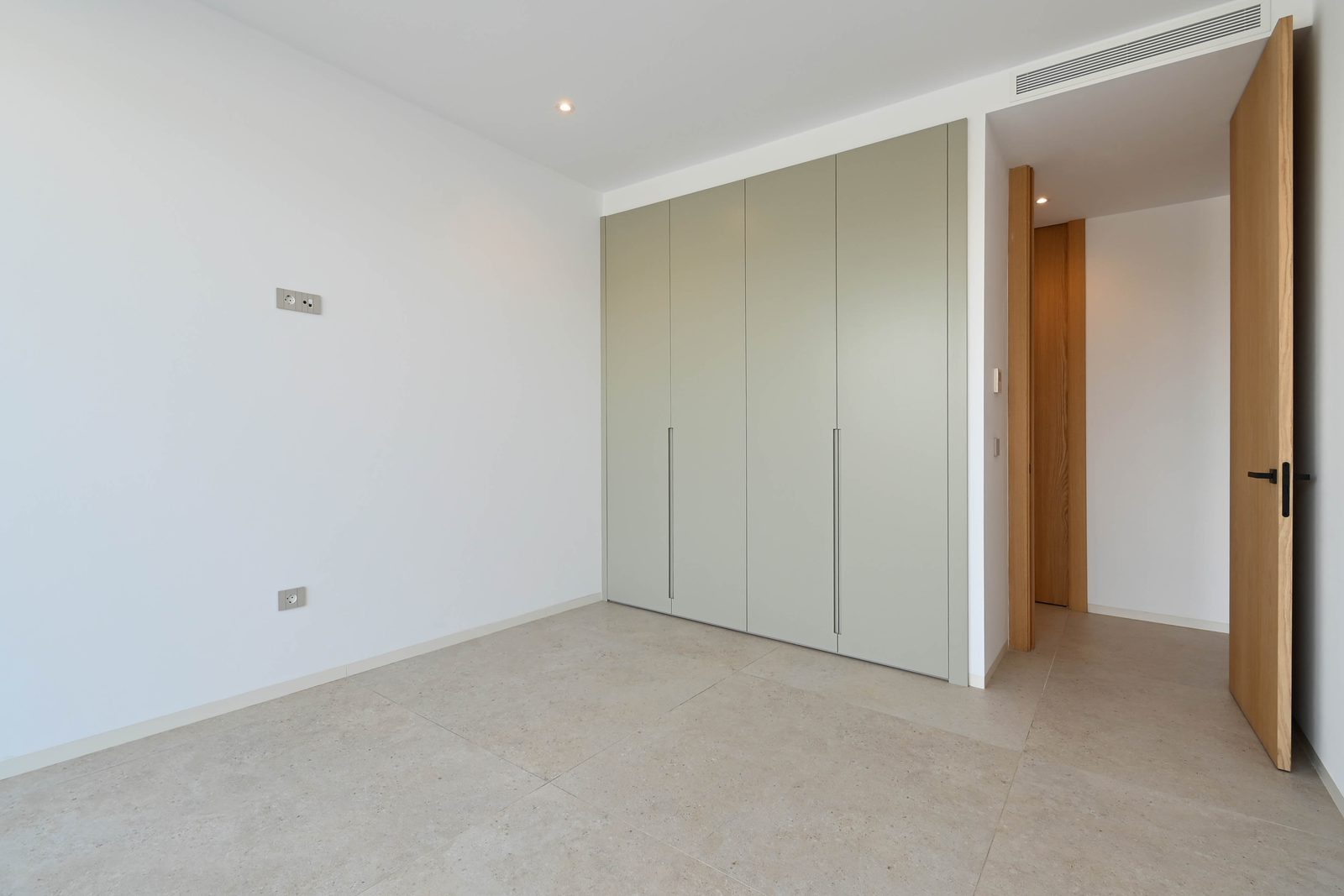 Bedroom with fitted wardrobes and tiled flooring in a 4-bedroom villa in Benissa - The Estates