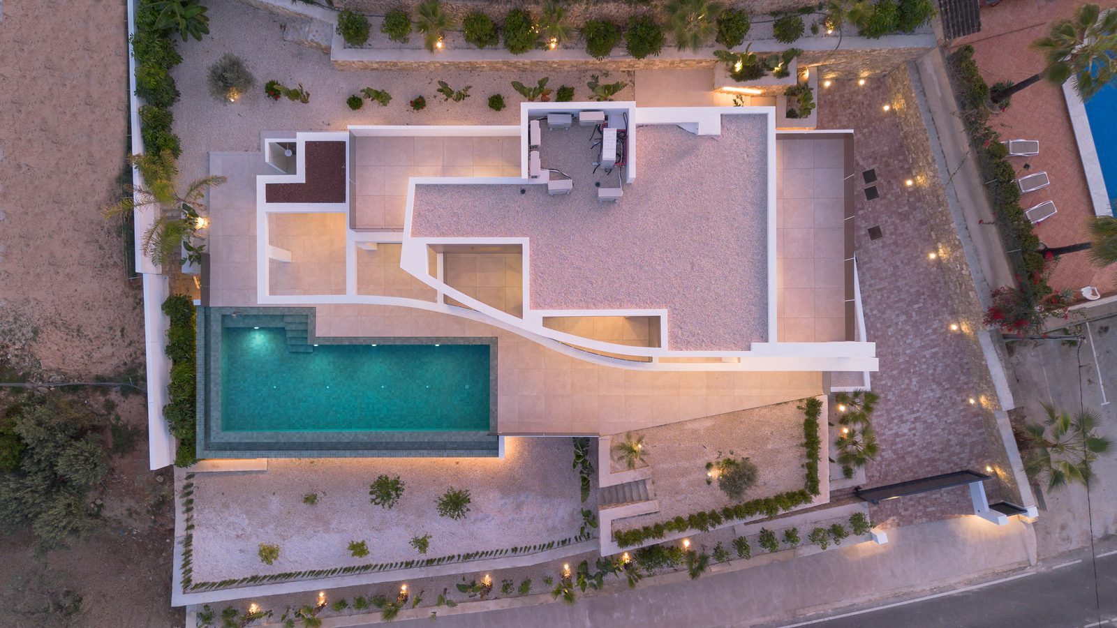 Aerial view of a modern villa with pool, terraces and landscaped gardens in Benissa - The Estates