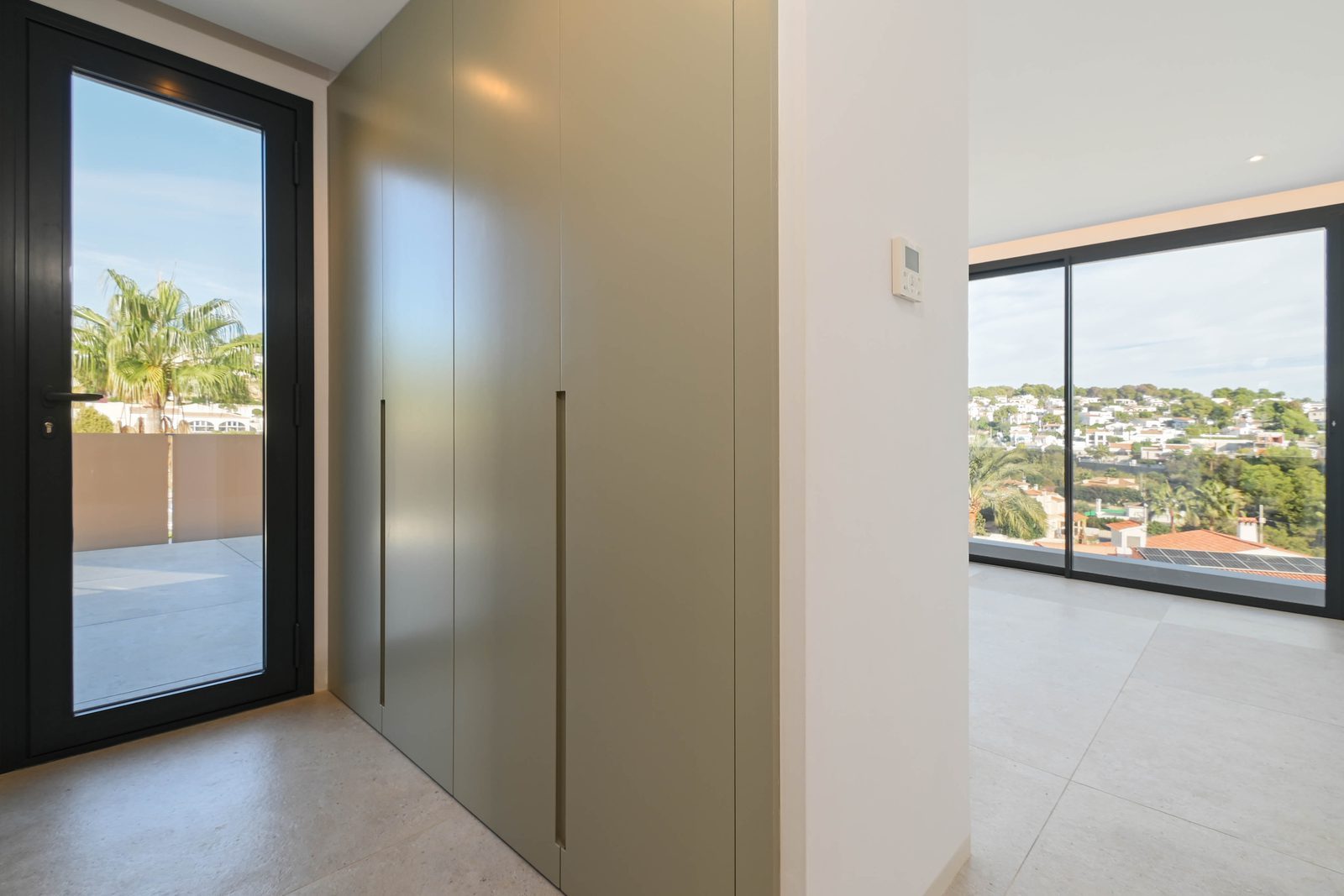 Built-in wardrobes, balcony door and scenic views in a 4-bedroom