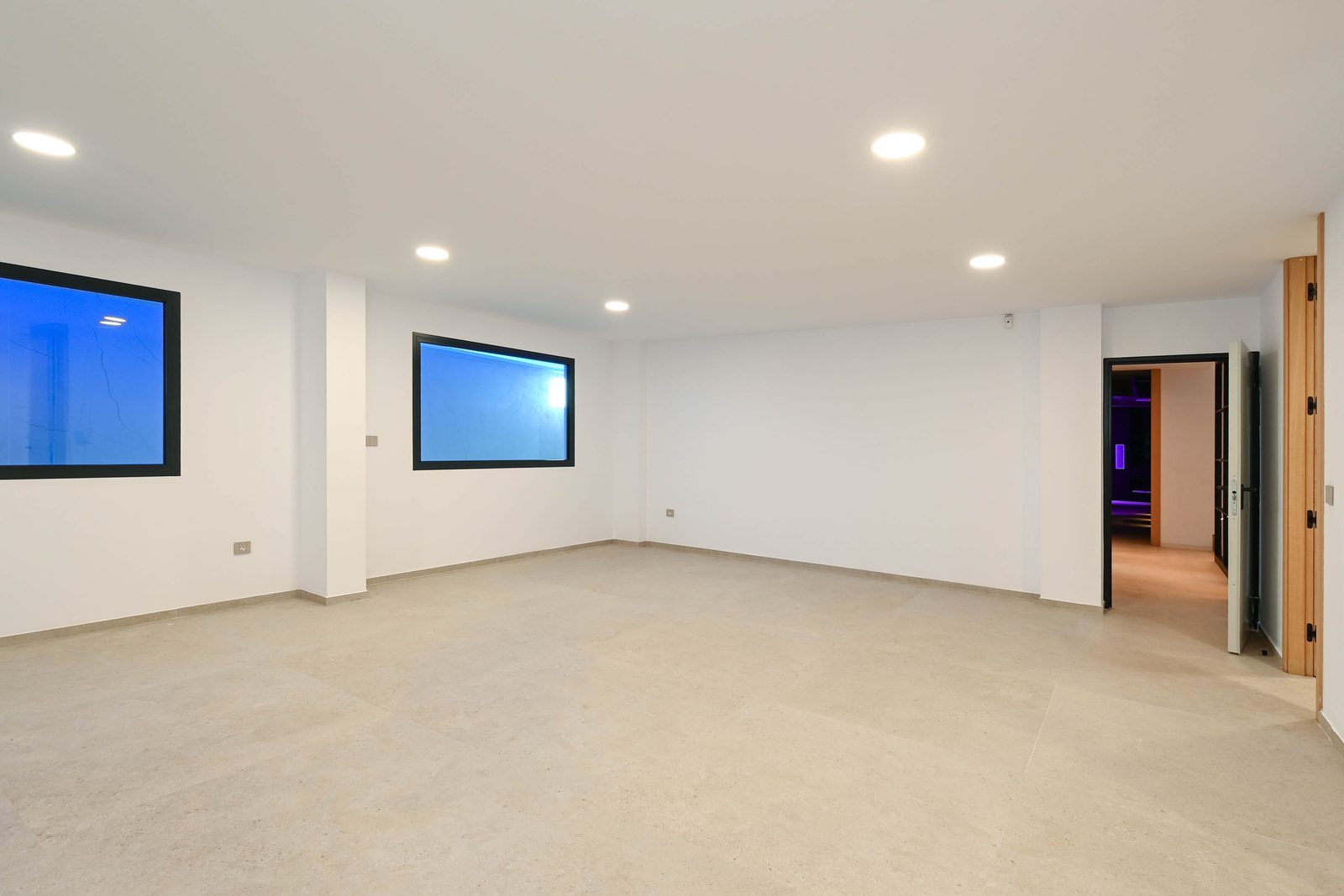 Spacious empty interior room with tiled floors and recessed lighting in a 4-bedroom villa in Benissa - The Estates