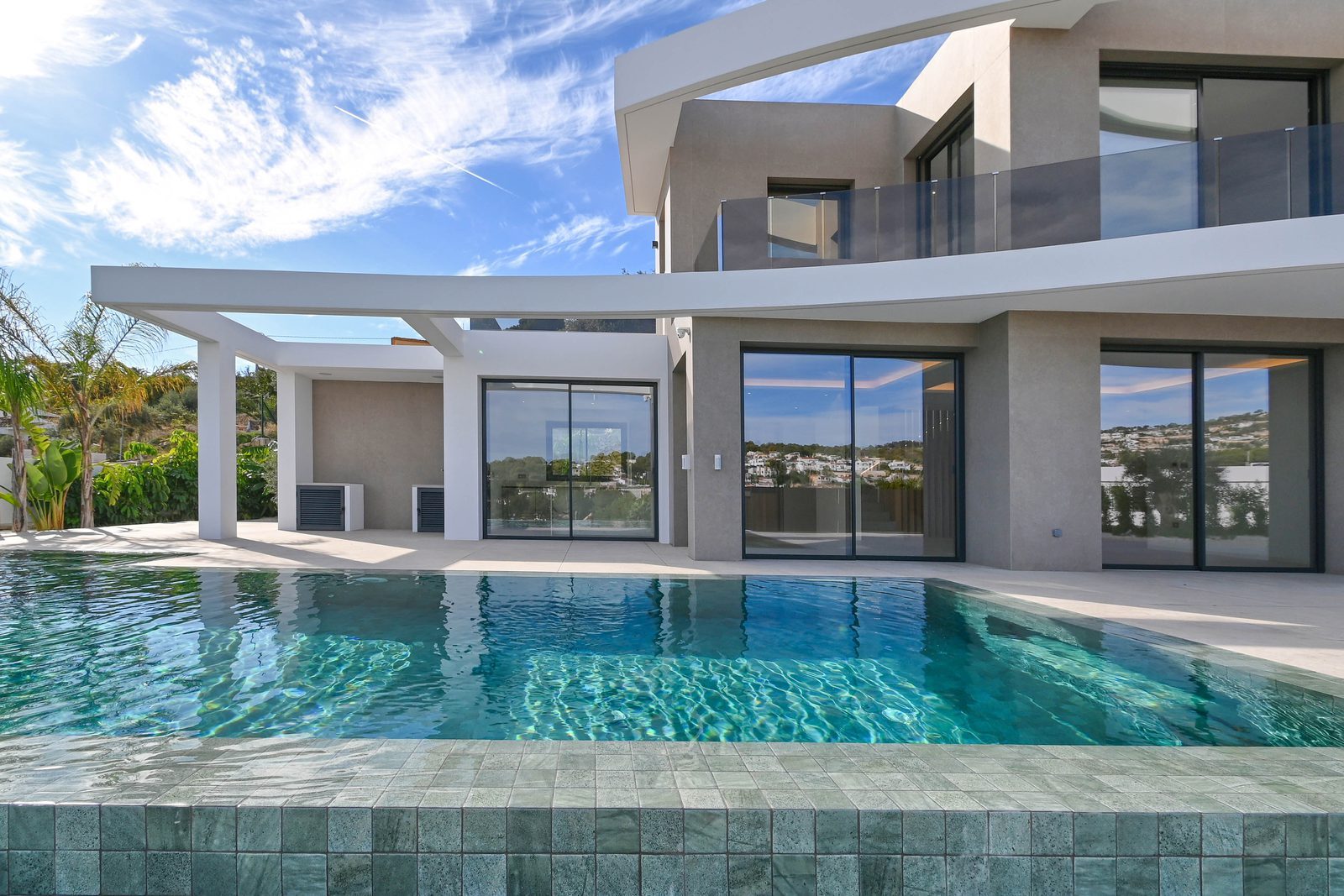 Modern villa exterior with swimming pool, terraces and sea views in Benissa - The Estates