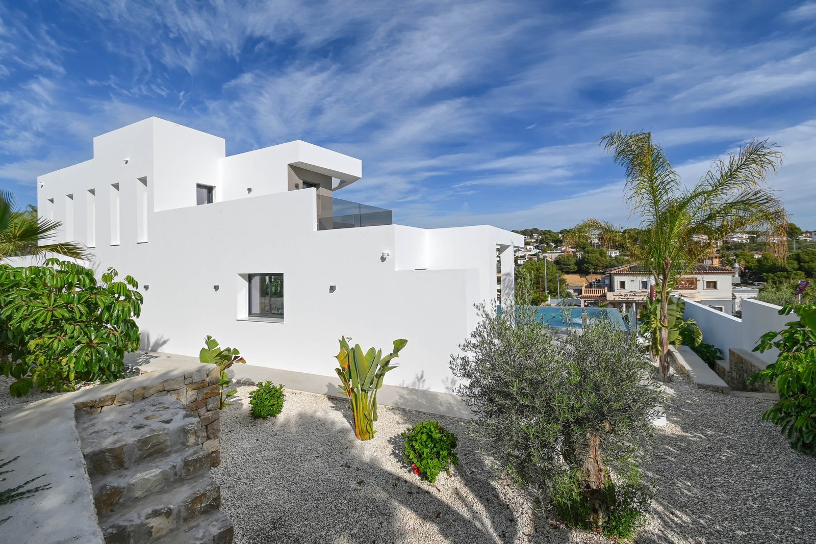 Modern white villa exterior with landscaped garden and terrace of a 4-bedroom villa in Benissa - The Estates