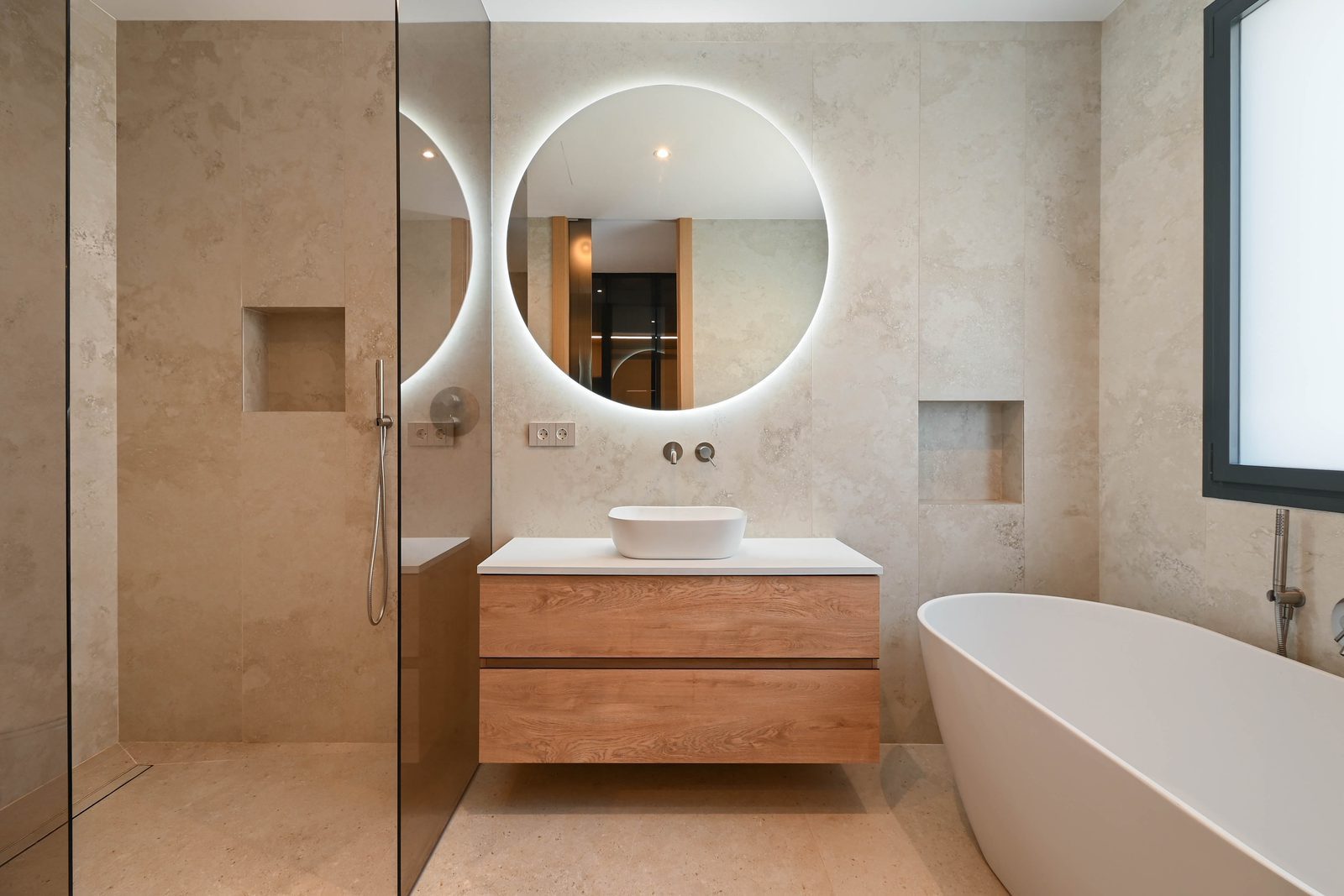 Contemporary bathroom with walk-in shower, freestanding bathtub and illuminated round mirror in a 4-bedroom villa in Benissa - The Estates