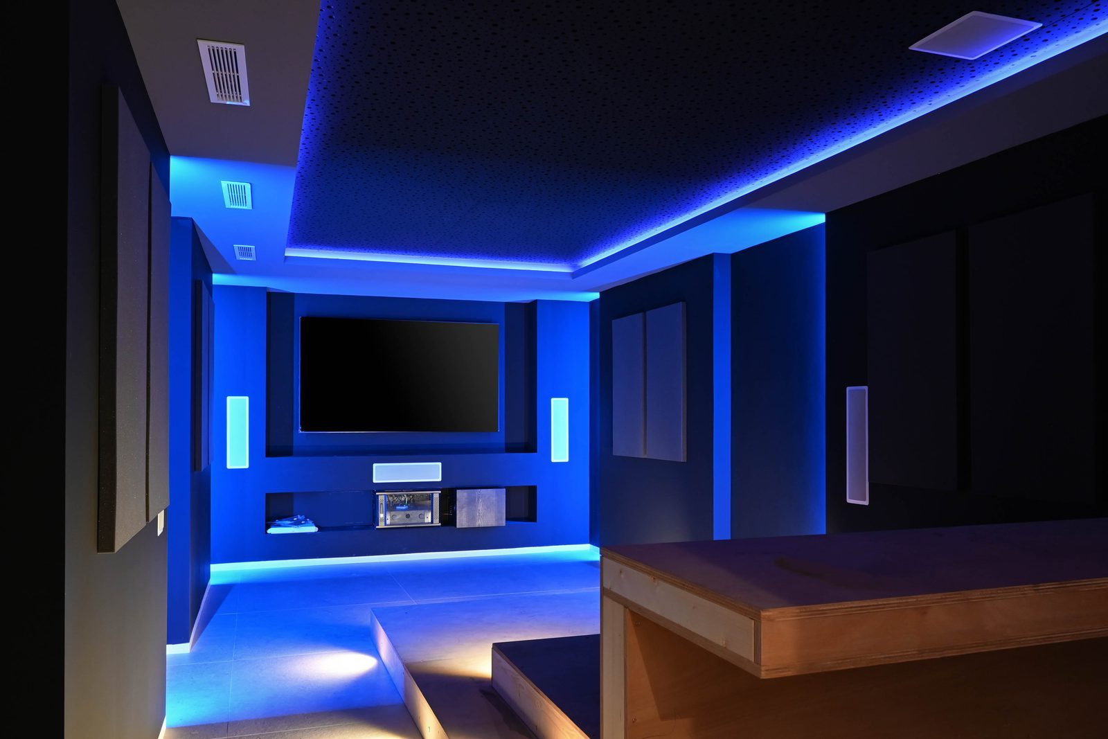 Blue-lit home cinema with large screen and surround speakers of a 4-bedroom villa in Benissa - The Estates