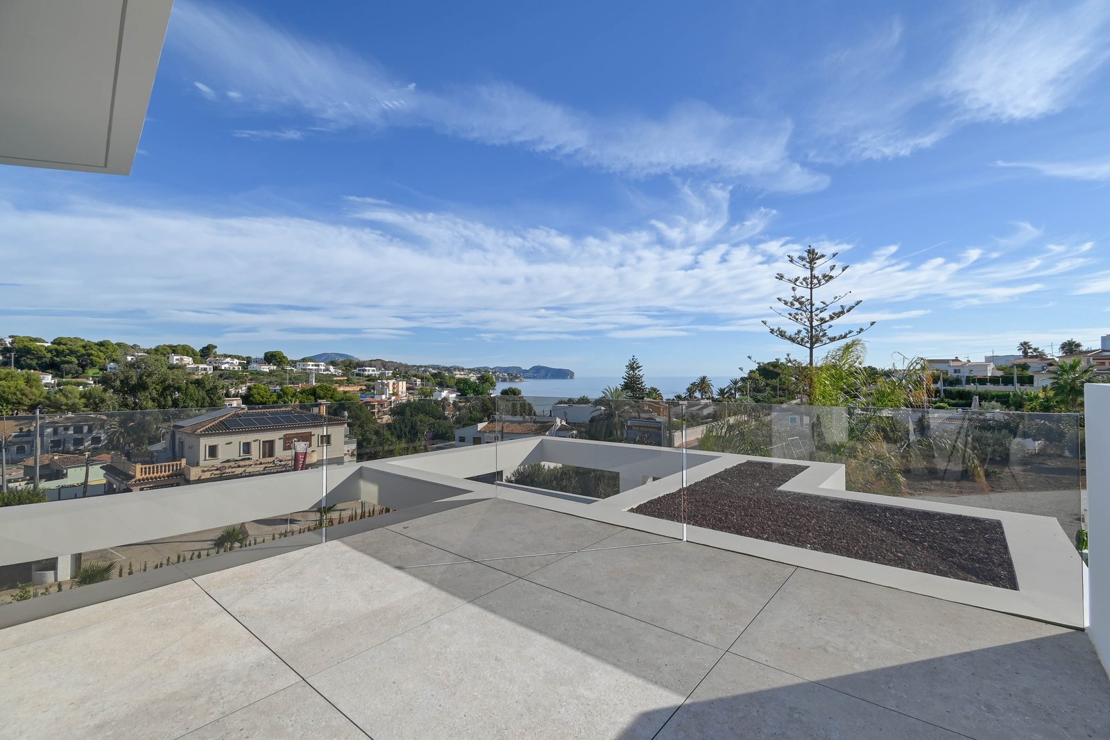 Sea-view terrace overlooking the coast and surrounding homes of a 4-bedroom villa in Benissa - The Estates