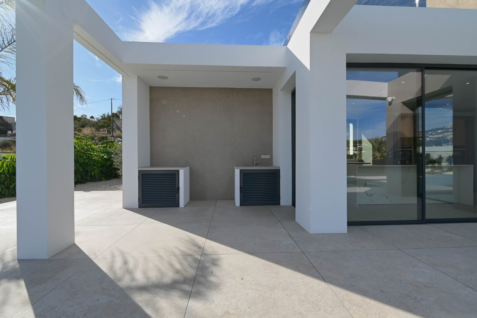 Covered outdoor kitchen and terrace with sea views at a 4-bedroom villa in Benissa - The Estates