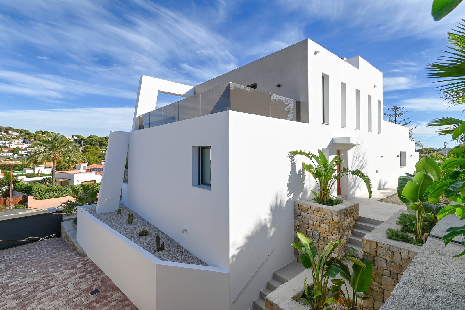 Modern white villa exterior with landscaped terraces of a 4-bedroom villa in Benissa - The Estates