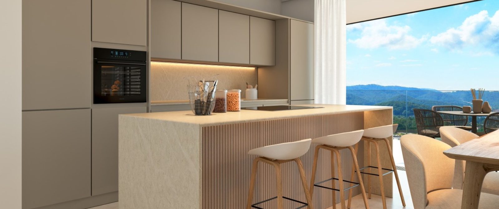 Modern kitchen with island breakfast bar, dining area and mountain views in a 2-bedroom apartment in Calvia - The Estates