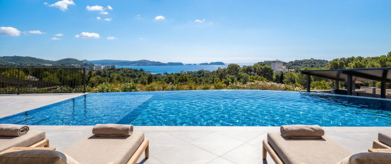 Infinity pool with loungers and sea views at a 2-bedroom