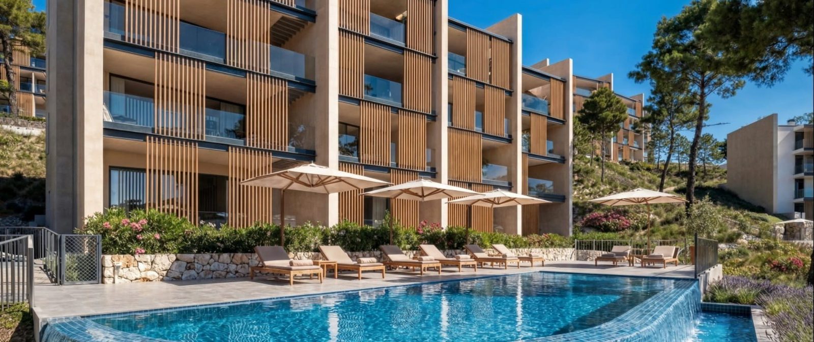Swimming pool and loungers outside a modern apartment building in Calvia - The Estates