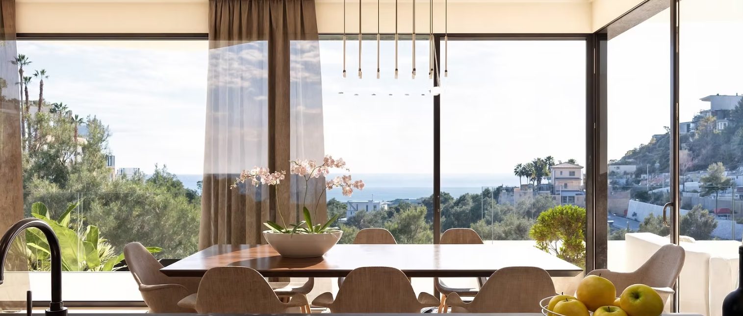 Bright dining area with floor-to-ceiling windows and panoramic sea views in a 4-bedroom villa in Benissa - The Estates