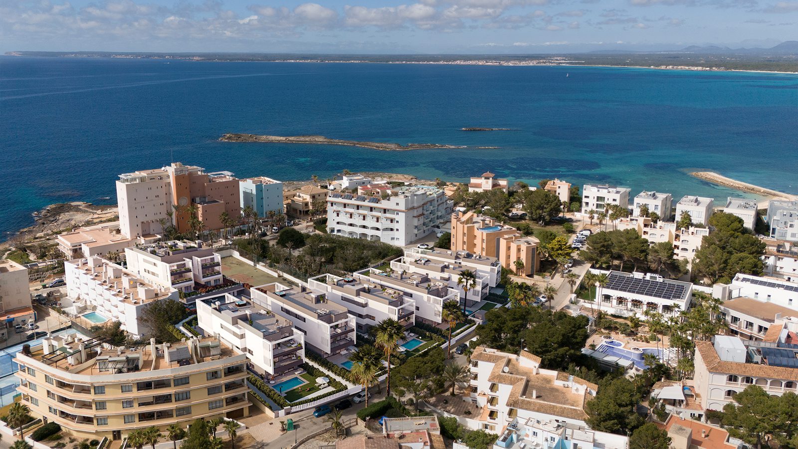 Aerial view of Colonia de Sant Jordi coastline, turquoise sea and surrounding apartments in Mallorca - The Estates