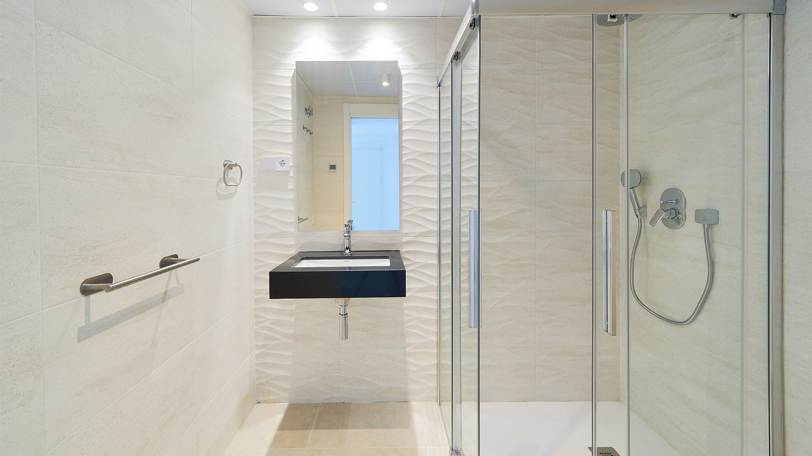 Modern bathroom with walk-in glass shower and floating vanity in a 2-bedroom penthouse in Fuengirola - The Estates
