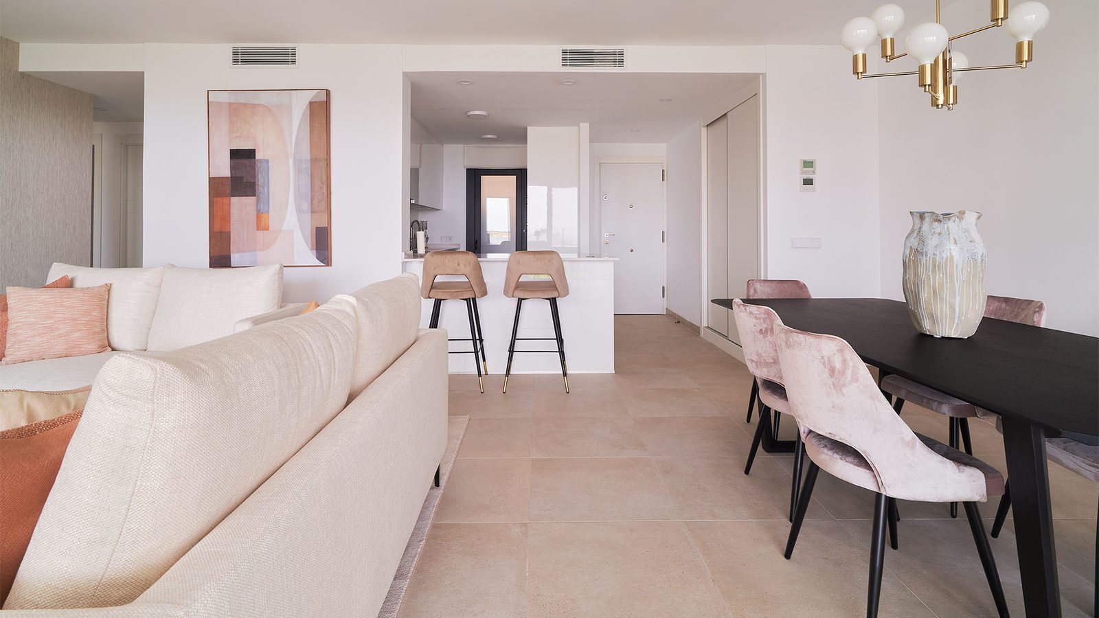 Open-plan living and dining area with kitchen island in a 2-bedroom penthouse in Fuengirola - The Estates