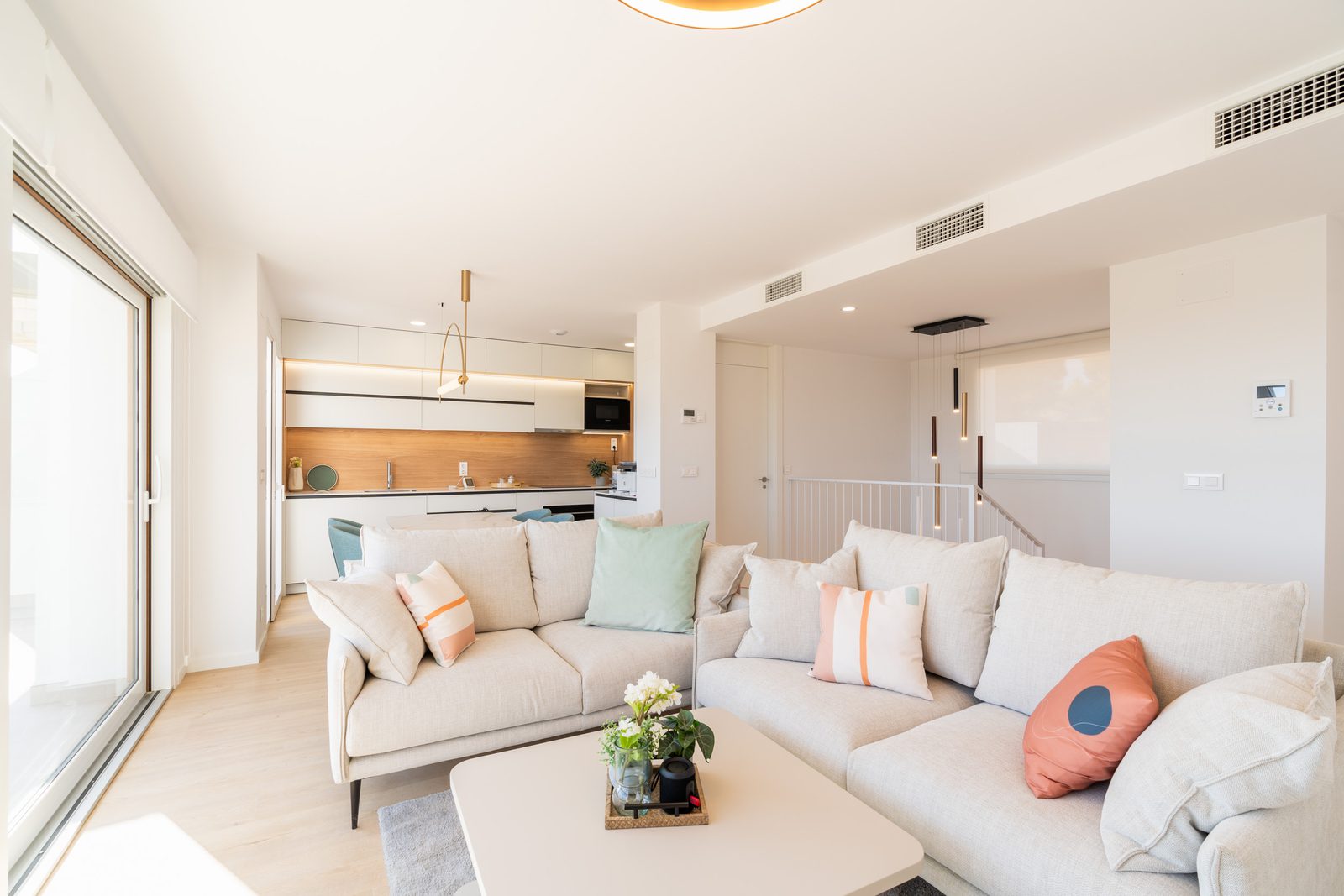 A bright living room and kitchen area of a 4-bedroom townhouse in La Nucía - The Estates