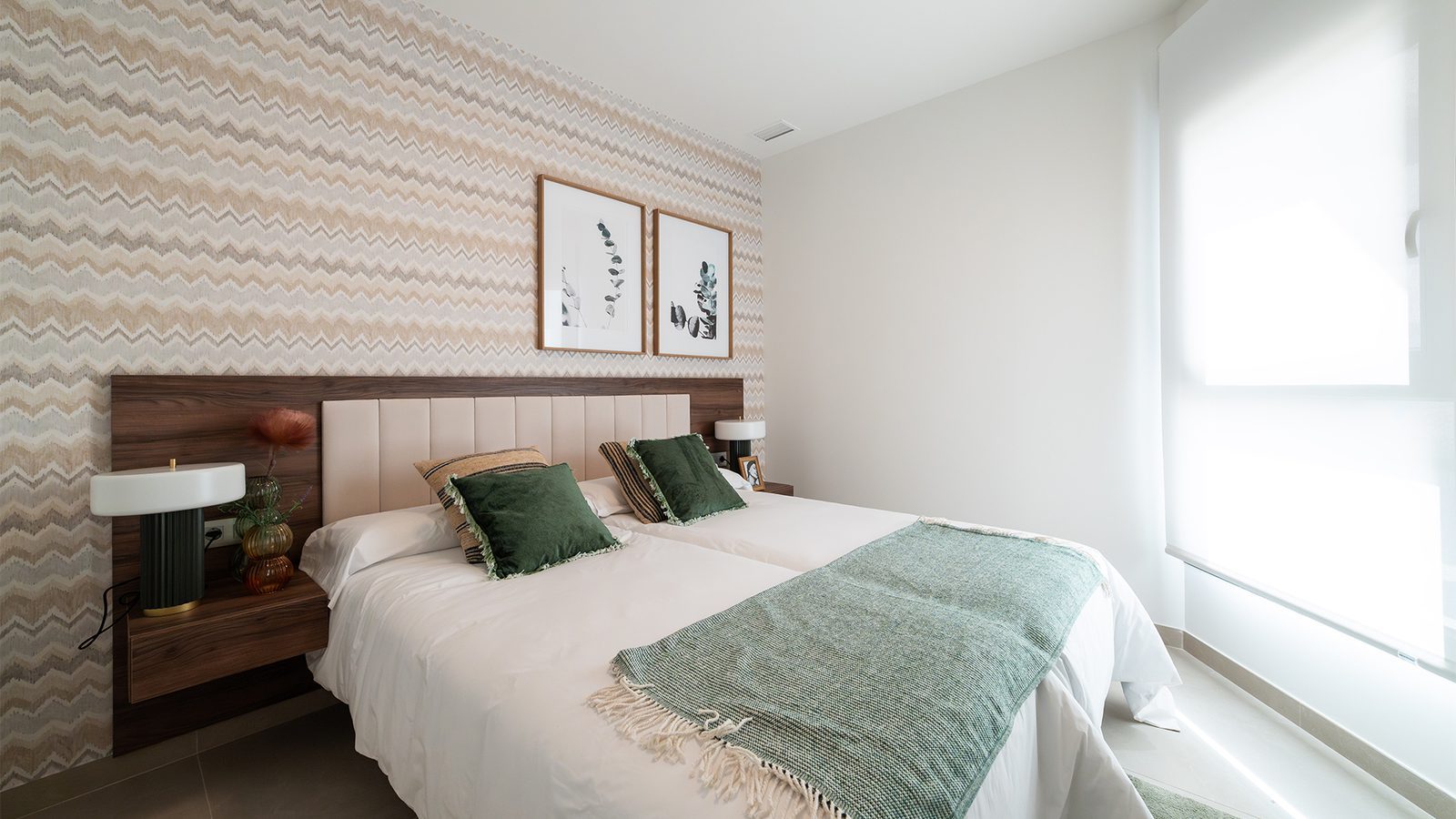 Bright double bedroom with patterned wallpaper, upholstered headboard and sea-facing window in a 3-bedroom apartment in Benidorm - The Estates
