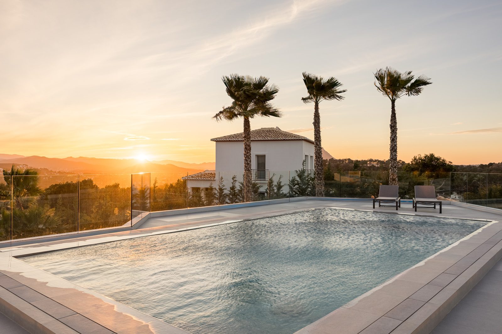 A stunning pool and villa exterior with panoramic sea views of a 5-bedroom villa in Portixol - The Estates
