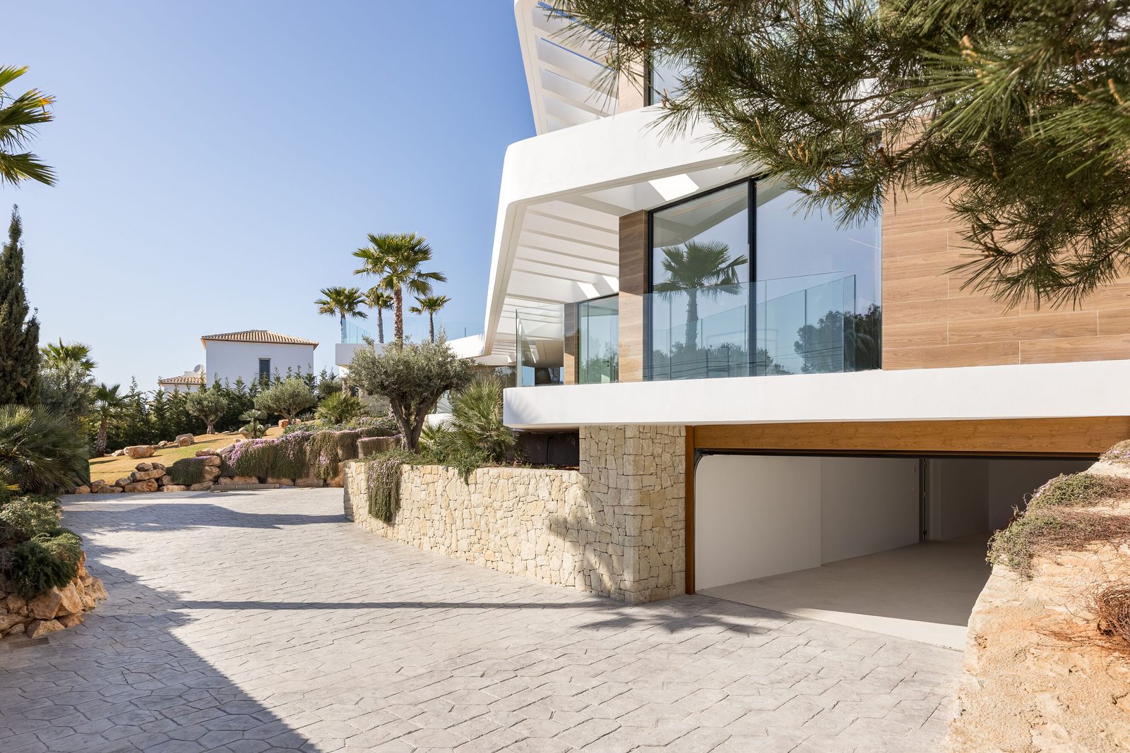 Modern exterior architecture and landscaping of a 5-bedroom villa in Portixol - The Estates