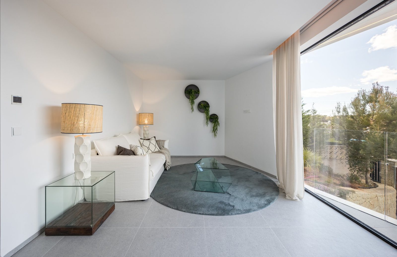 Stylish living room with large windows and sea views of a 5-bedroom villa in Portixol - The Estates