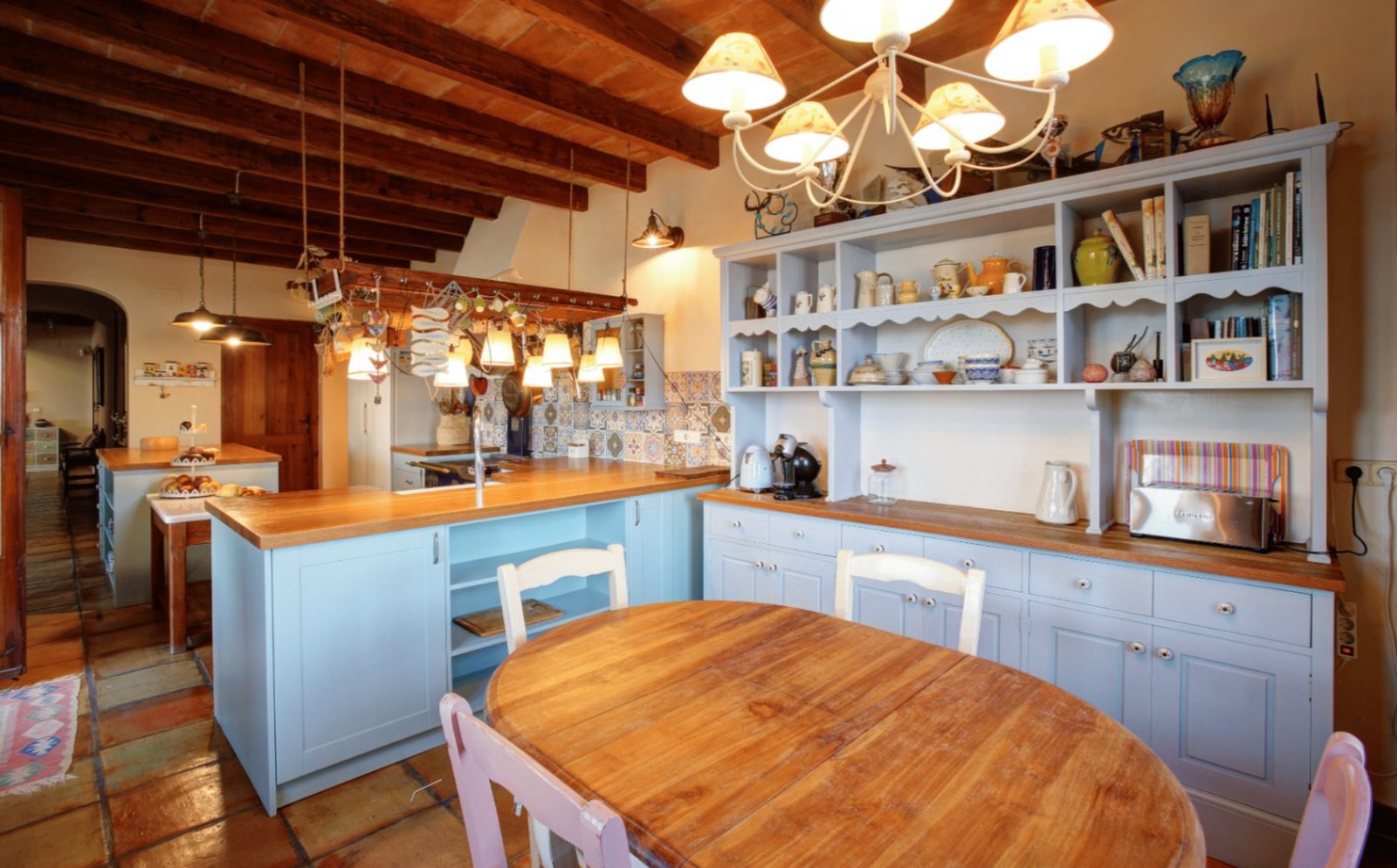 A bright kitchen with wooden beams and a breakfast area in a 4-bedroom finca in Moraira - The Estates