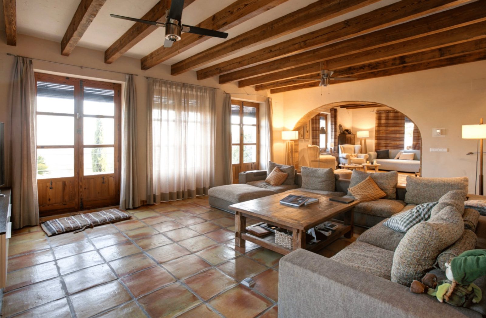 A bright living room with exposed beams and tiled floors in a 4-bedroom finca in Moraira - The Estates